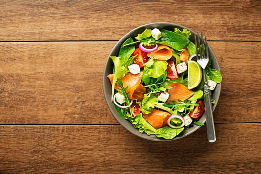 Fresh green salad with smoked salmon and cheese