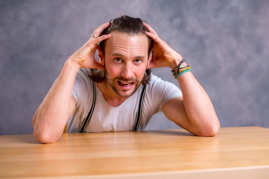 young bearded man lokking shocked  in to the camera