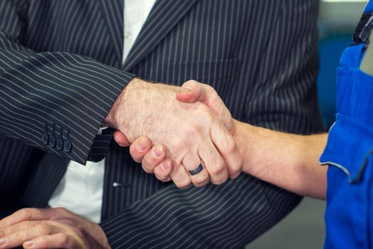 handshake- hands of  boss and worker