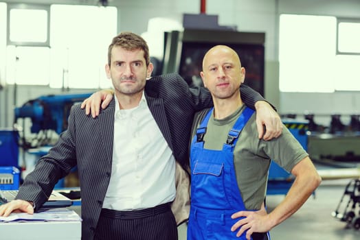 hugging-  boss and worker on work bench