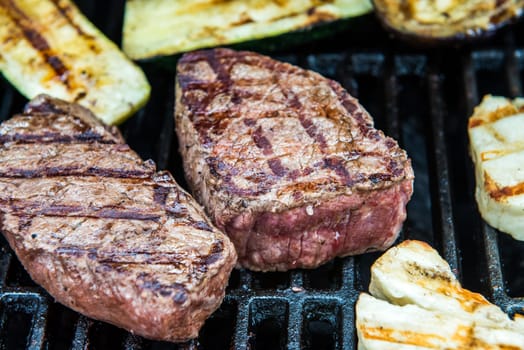 beef steak with different vegetables on barbecue