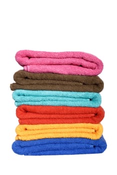Stack of folded colorful towels isolated over white background