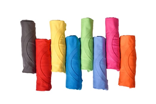 Row of colorful rolled clothes isolated over white background