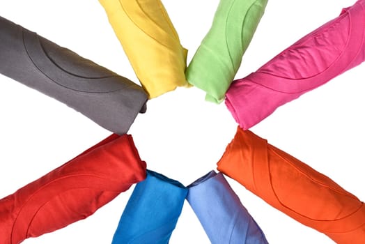 Row of rolled colored clothes isolated over white background