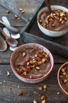 Delicious chocolate pudding with roasted almonds and caramel sauce