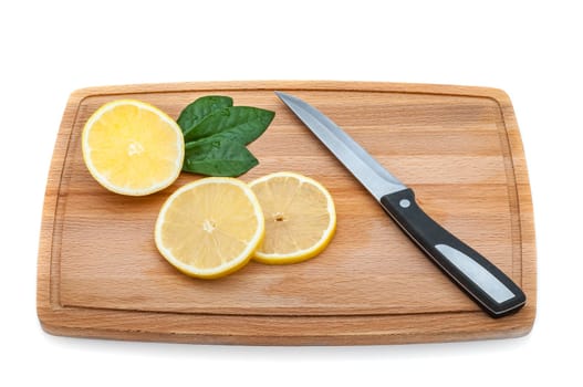 There are a few slices of lemon and a knife on the cutting board.
