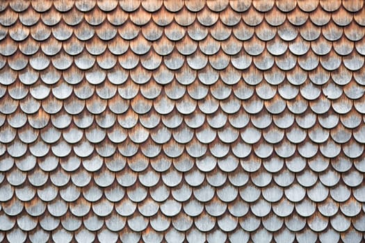 Traditional wooden shingles wall of an Austrian house.