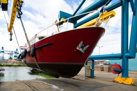 Boat crane lifting a motorboat.