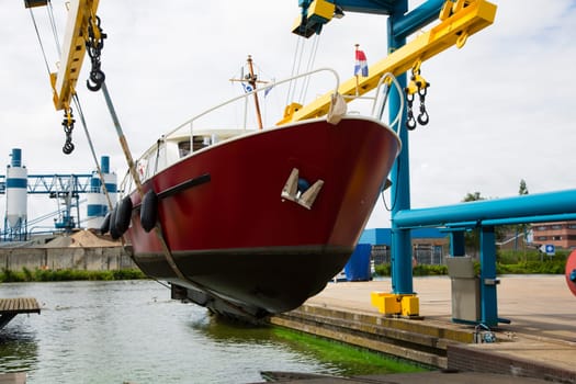 Boat crane lifting a motorboat.