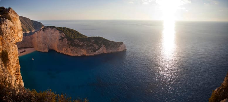 Navagio beach with shipwreck against sunset on Zakynthos island in Greece