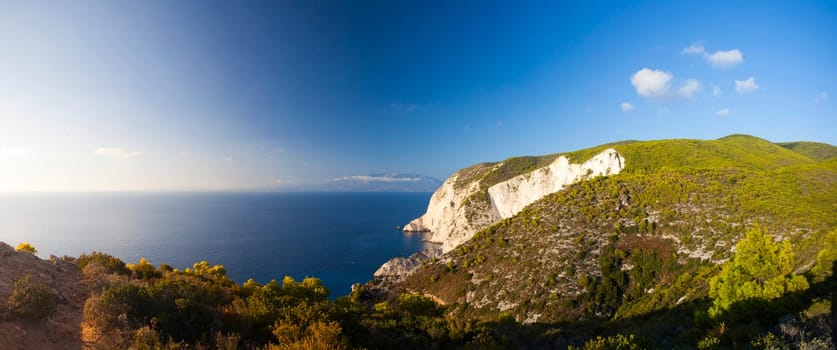 Hight cliffs and blue water against sunset on Zakynthos island in Greece
