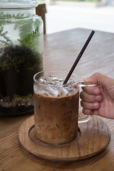Hand on glass of iced coffee mocha, stock photo