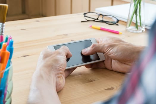 Black Scott shirt businessman chat smartphone or mobile phone in home office. Smartphone or mobile phone and pen and laptop and eyeglasses. Social or internet and technology communication concept