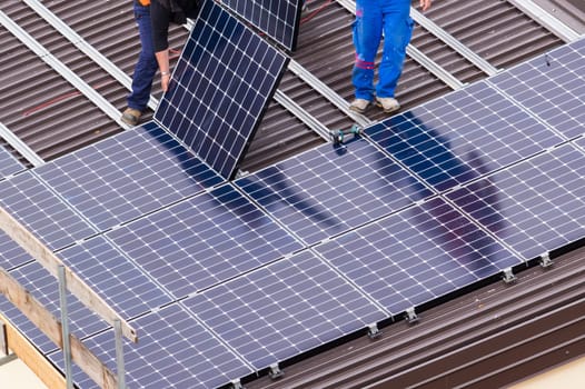 Installation of solar panels on a roof.