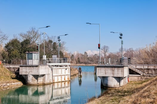 Canal lock and traffic light for regulation of boat traffic.