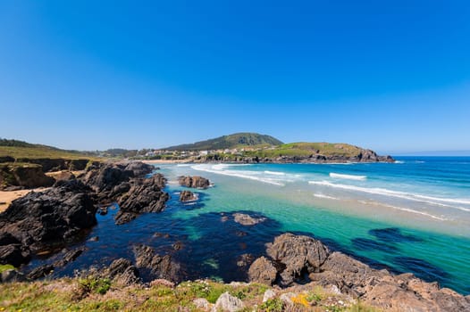 Landscape with sea,cliff, beach and blue sky. Galicia Spain. Vacation travel.
