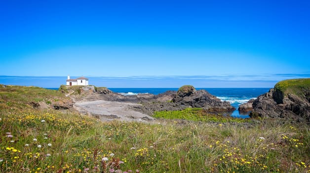 The hermitage of the Virgen del Puerto in Meirás, A Coruna, Galicia, Spain.Landscape of the coast of Galicia, lighthouse.