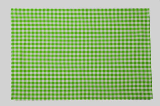 Green and white checkered napkin isolated on white background.