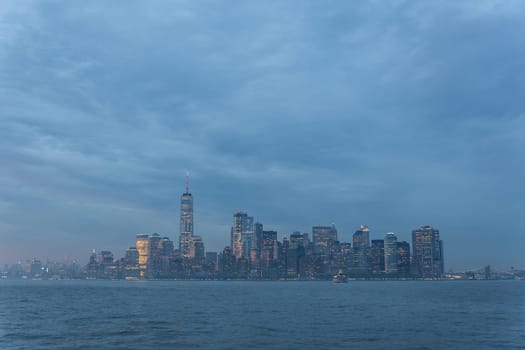 Dramatic panoramic view of storm over Lower Manhattan from Ellis Island at dusk, New York City.