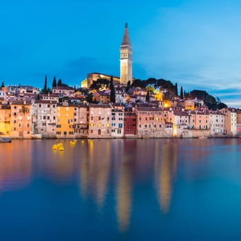 Colorful sunset of Rovinj town, Croatian fishing port on the west coast of the Istrian peninsula. Colorful evening seascape of Adriatic Sea. Traveling concept.