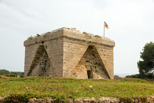 The old defence tower of Punta de N'Amer from the time of the Spanish civil war built of rocks from the east coast of the Spanish Mediterranean island Mallorca