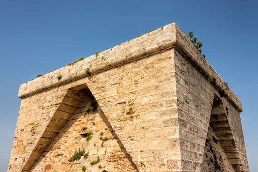 The old defence tower of Punta de N'Amer from the time of the Spanish civil war built of rocks from the east coast of the Spanish Mediterranean island Mallorca