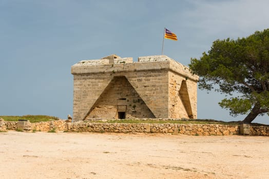 The old defence tower of Punta de N'Amer from the time of the Spanish civil war built of rocks from the east coast of the Spanish Mediterranean island Mallorca