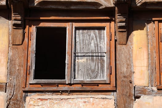 old windows on an old condemned wooden house