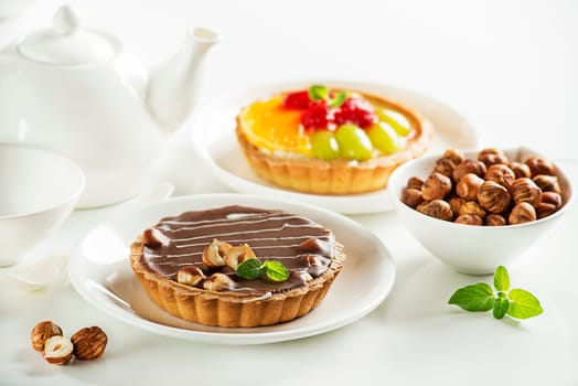 Delicio caramel chocolate tart topped with nuts and fruit