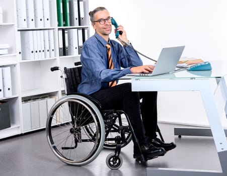disabled business man in wheelchair working in the office