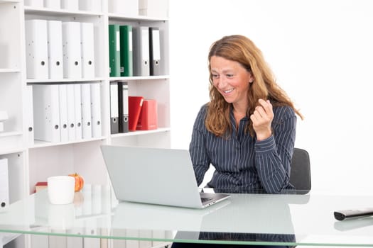 young amazed business woman at his desk