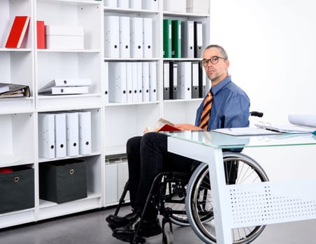 disabled business man in wheelchair working in the office