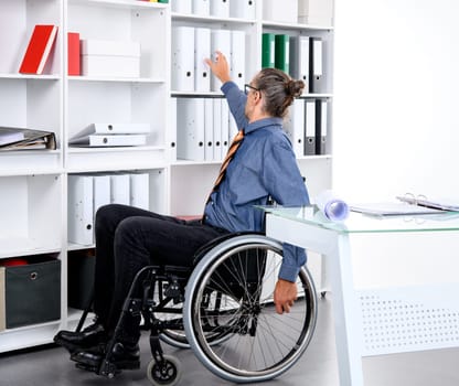 disabled business man in wheelchair working  in the office