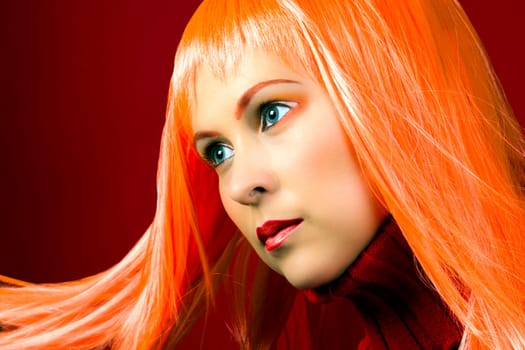 Beauty portrait of woman with orange hair and makeup.
