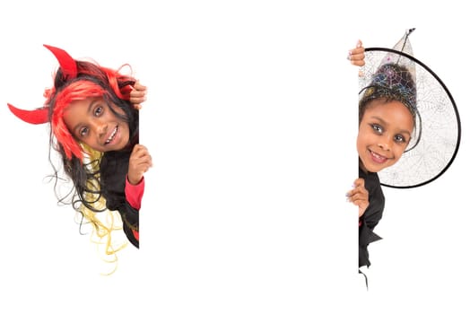 Girls with face-paint and Halloween costumes over a white background