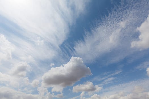 Beautiful white clouds and blue sky background over England UK. Fluffy and wispy cloudscape backdrop