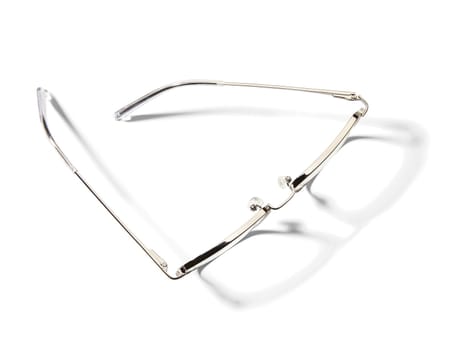 High angle view of pair of eyeglasses on white background with shadow.