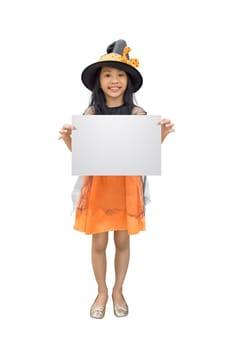 Funny asian girl in witch costume holding empty copyspace isolated over white background
