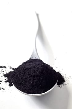 Spoonful of organic activated food grade charcoal used to adsorb toxins and cleanse and detoxify the body