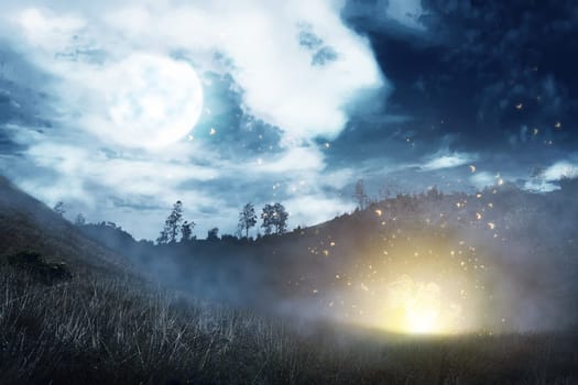 Misty hill with dark cloud and full moon on the night. Halloween background