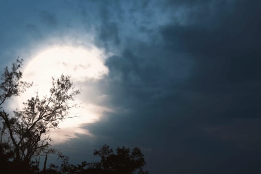 Spooky night scene with moon and dark clouds on the sky