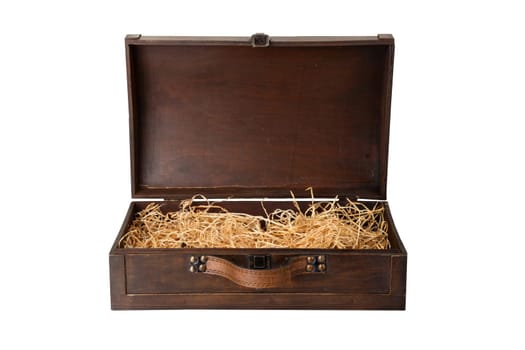 Opened old wooden chest with a leather handle, filled with wood wool isolated on white background. Space for text display montage.