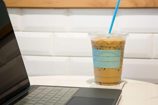 Laptop on table in coffee shop, stock photo