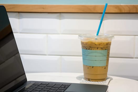 Laptop on table in coffee shop, stock photo