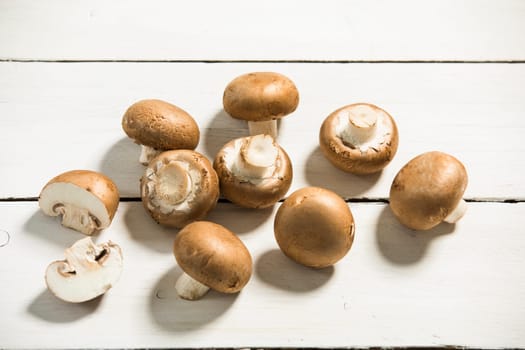 brown mushrooms on a white wooden plate