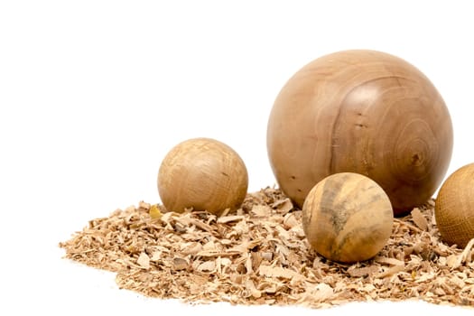 Hand-turned wooden balls decorated with sawdust isolated on white