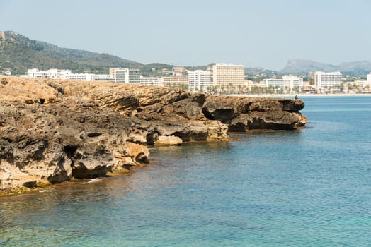 View over the clear turquoise waters of the Mediterranean to the beach of Cala Millor on the Spanish Mediterranean island Mallocra