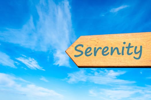 Wood arrow sign against clear blue sky with Serenity message,  hapiness concept