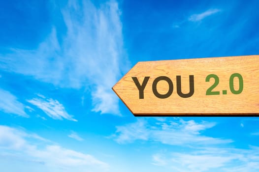 Wood arrow sign against clear blue sky with You 2.0 message, Lifestyle change conceptual image