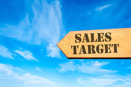 Wood arrow sign against clear blue sky with Sales target, Business profitability concept